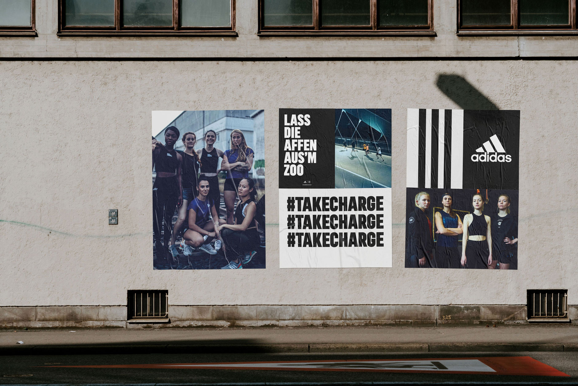 Grafikdesign und Konzept für die adidas Runners Frankfurt Drei Poster an einer Hausfassade hängend