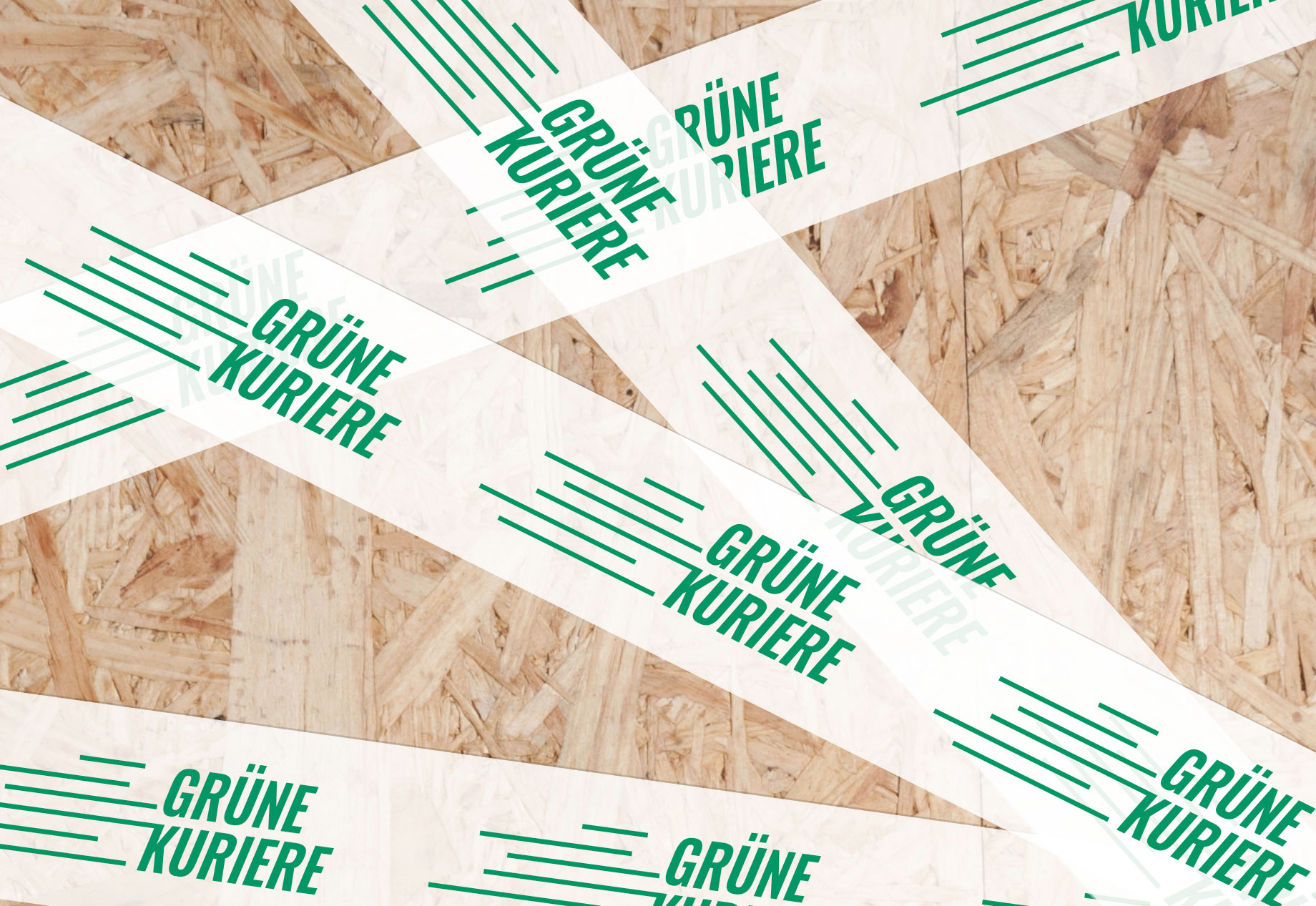 Logodesign für die Grünen Kuriere Klebeband kreuz und quer der Grünen Kuriere über eine Holzfläche geklebt
